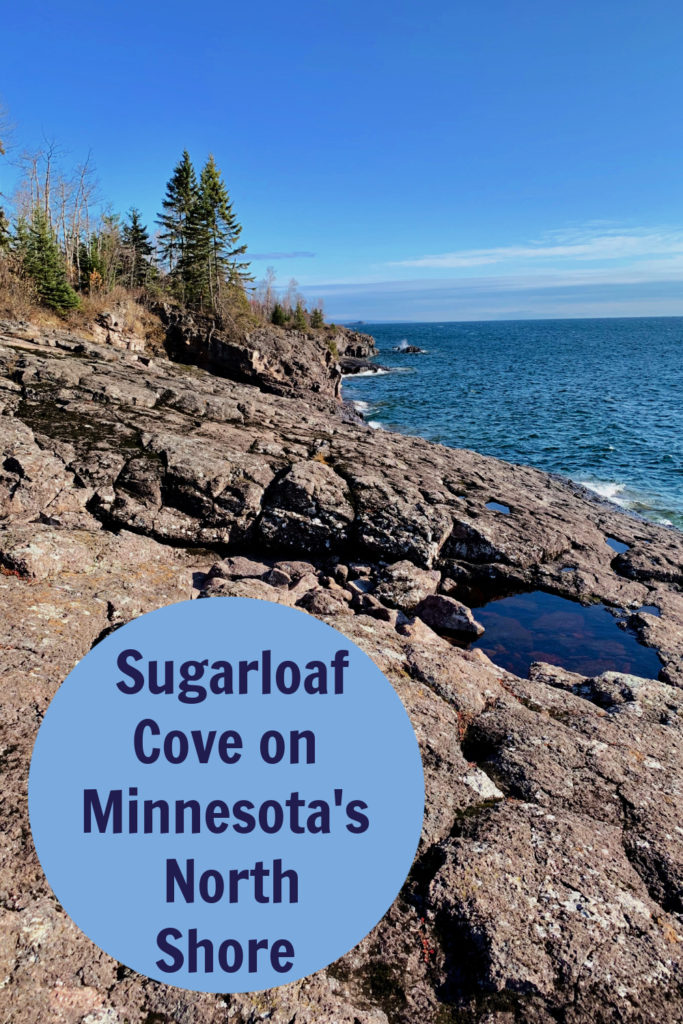 View looking down basalt rocks on Lake Superior's North Shore. Text overlay reads "Sugarloaf Cove on Minnesota's North Shore."