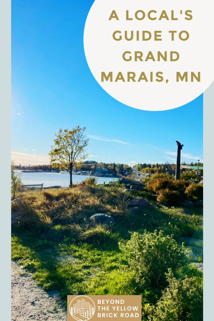 Photo of park next to Lake Superior in downtown Grand Marais. Text reads "A local's guide to Grand Marais, MN"