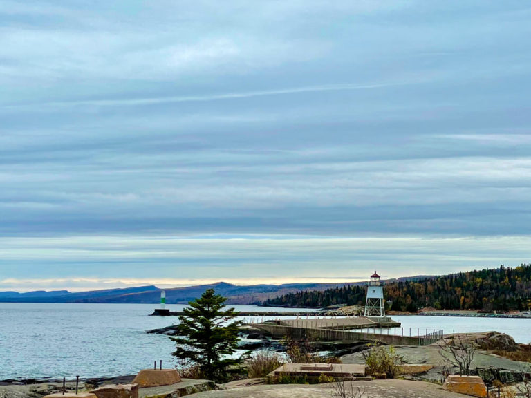 White lighthouse on Lake Superior on an overcast day.