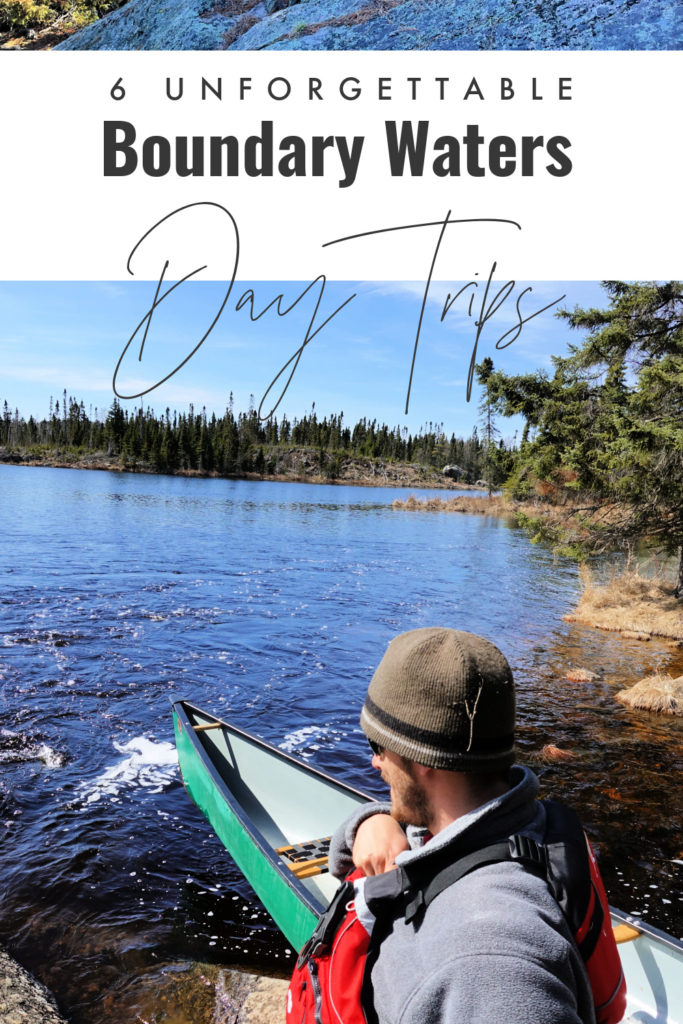Man stands next to a green canoe at a Boundary Waters portage landing.