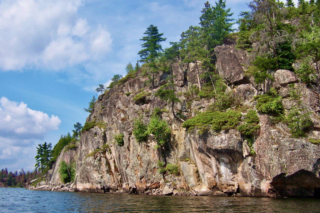 Tall granite cliffs rise above Seagull Lake on the Gunflint Trail