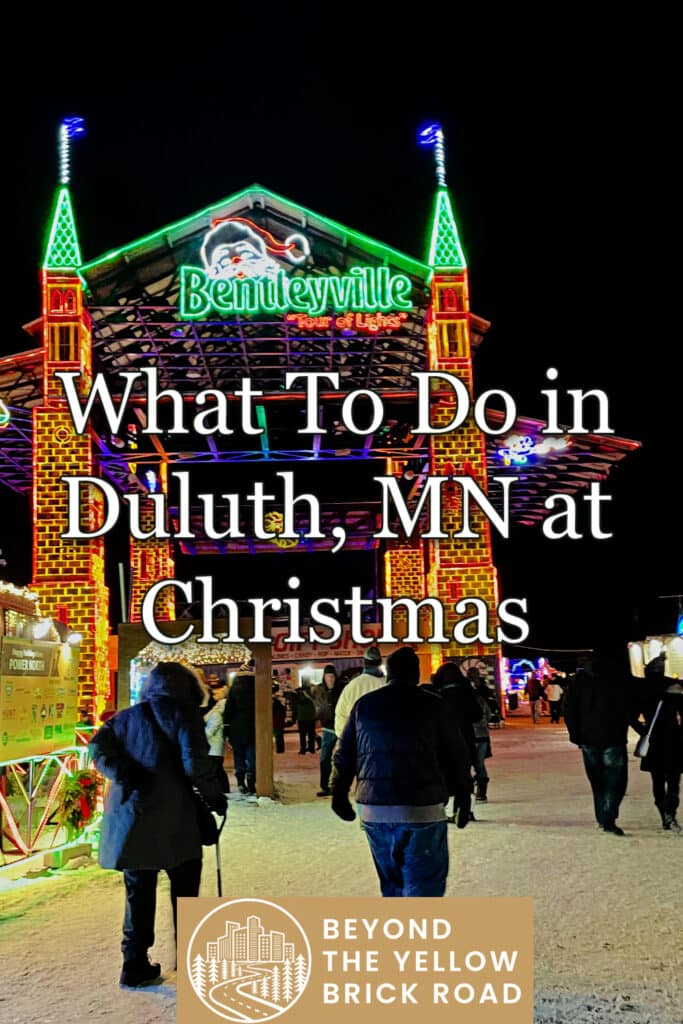 People approach a Christmas light display. Text reads "What To Do in Duluth, MN at Christmas."