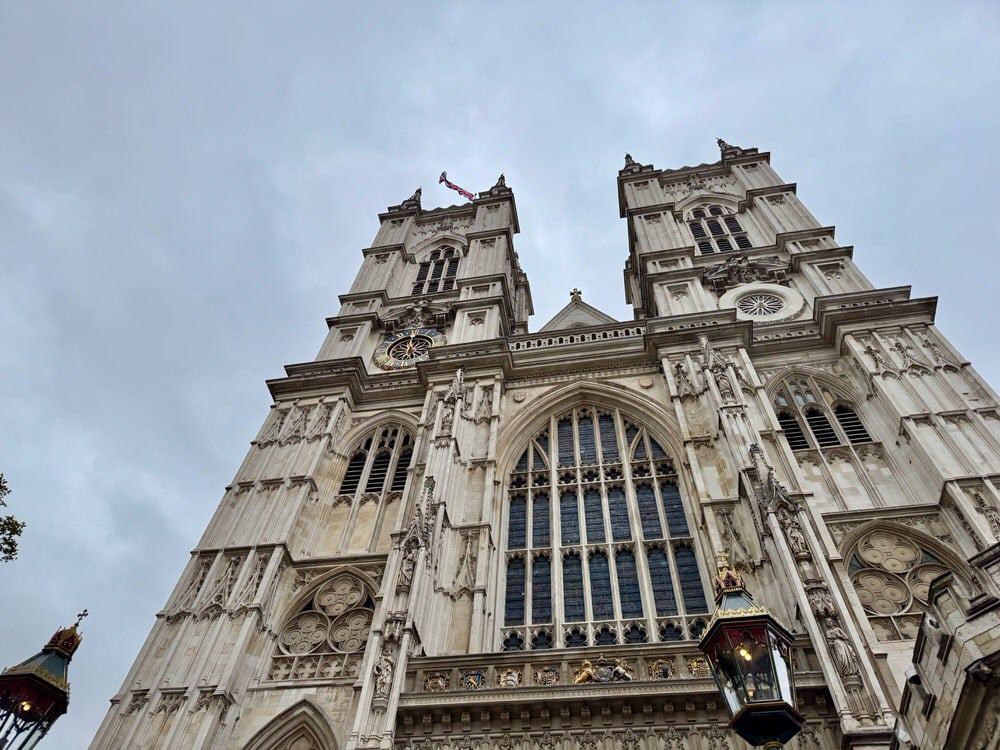 Looking up at Westminster Abbey from street level on a cloudy day