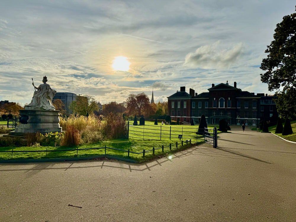 Late afternoon sun sets over Queen Victoria statue and walk up to Kensington Palace central London