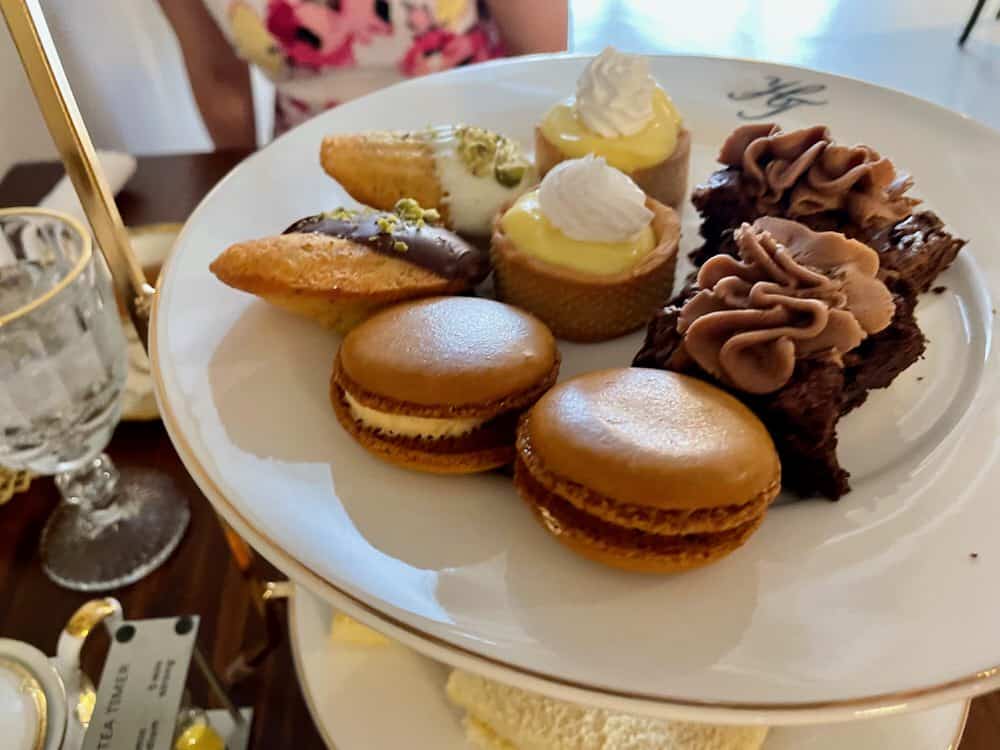 Selection of sweet treats on the top level of an afternoon tea service platter