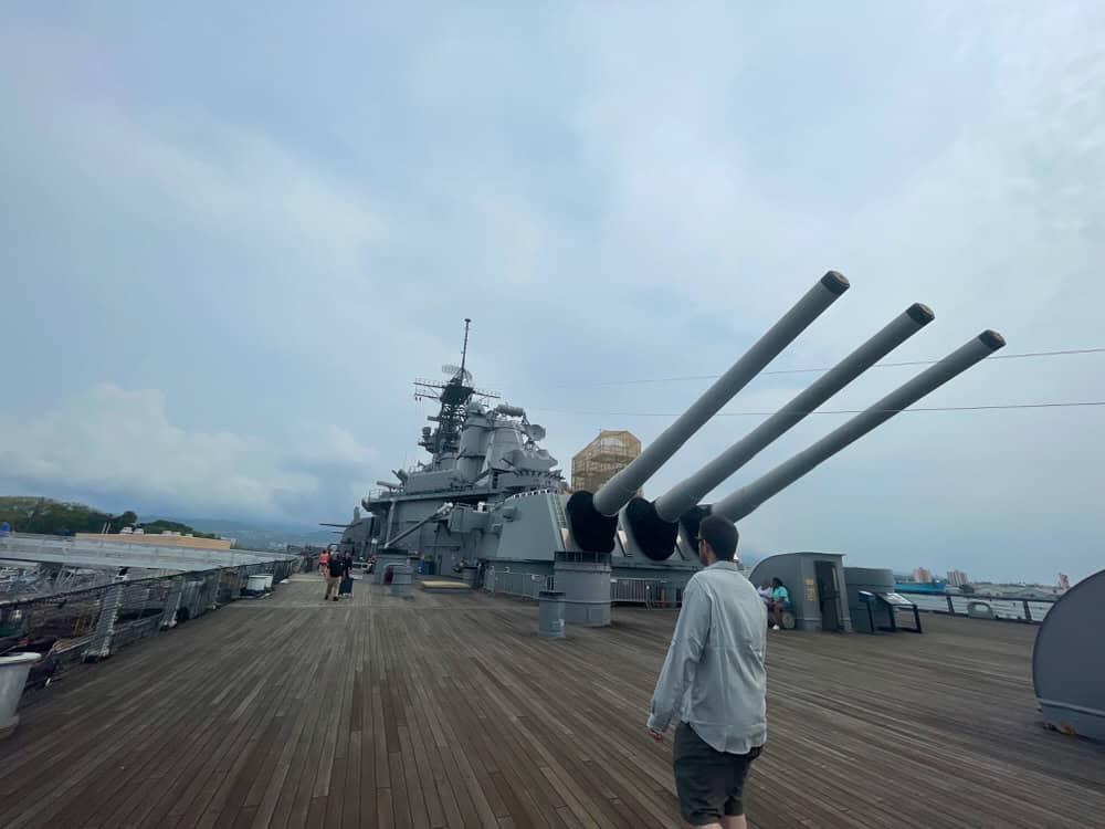 Man walks on the teak deck of the USS Missouri in Hawaii