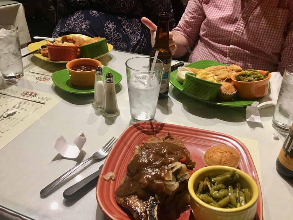 A table covered with plates of Southern food