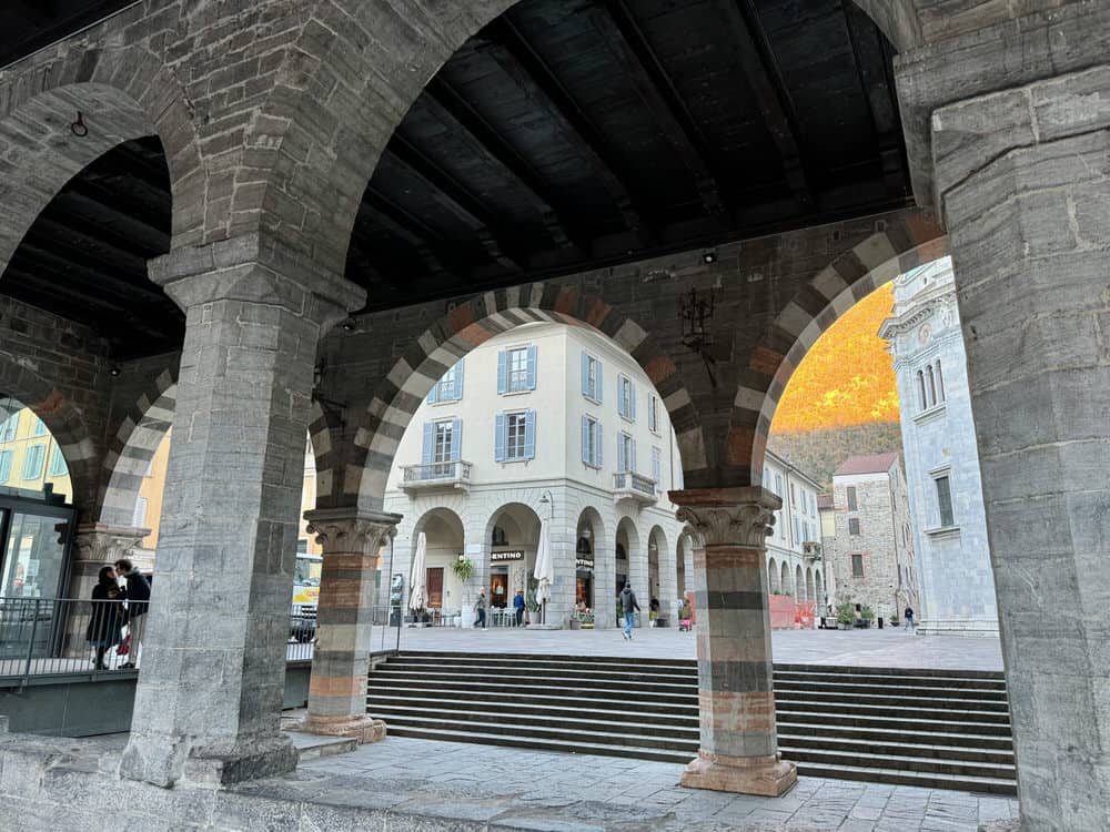 Stone arches outside cathedral in Como City Italy