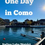 Looking across a pier on Lake Como to Como City. Text overlay reads "One Day in Come: Italian Lake District."