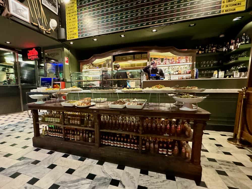 Indoor aperitivo buffet in front of an open kitchen