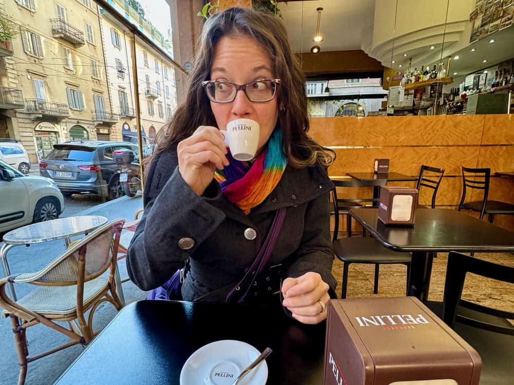 Woman sips espresso in a Milan cafe