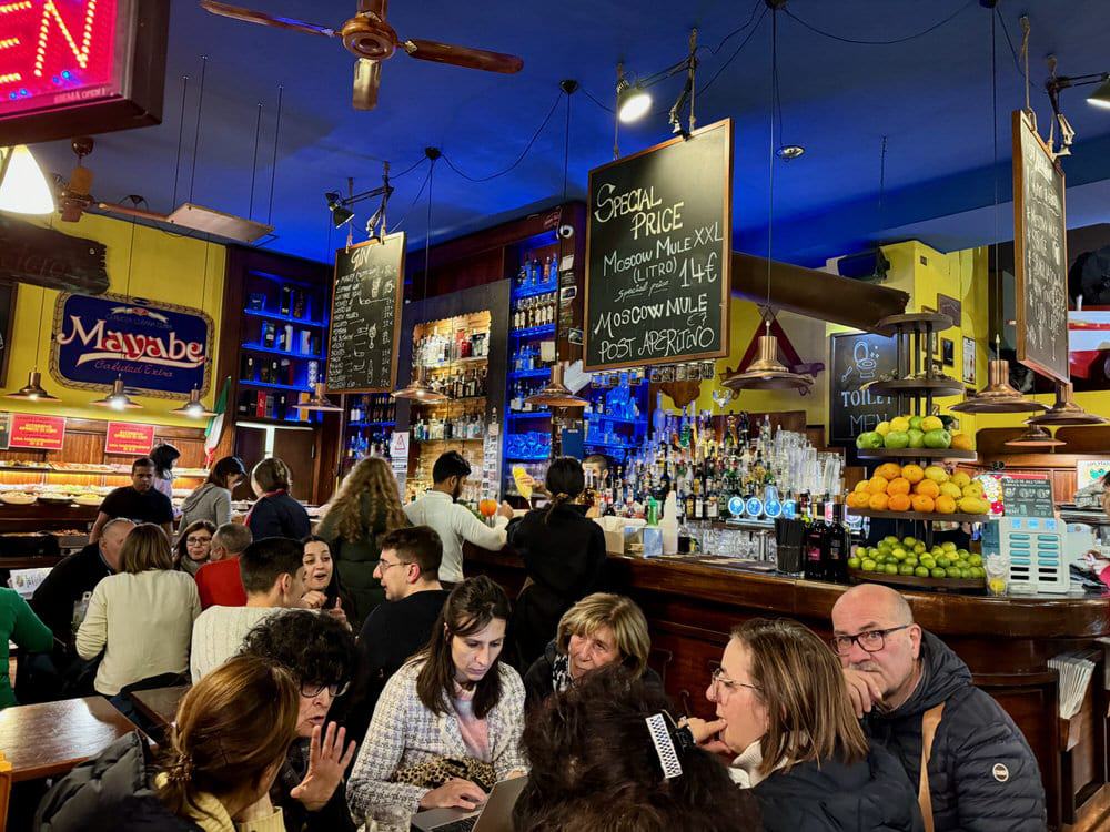 Crowded bar in Milan Italy La Hora Feliz buffet in the background