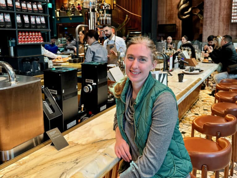 Woman sitting at a modern coffee bar in Starbucks Reserve Roastery Milano