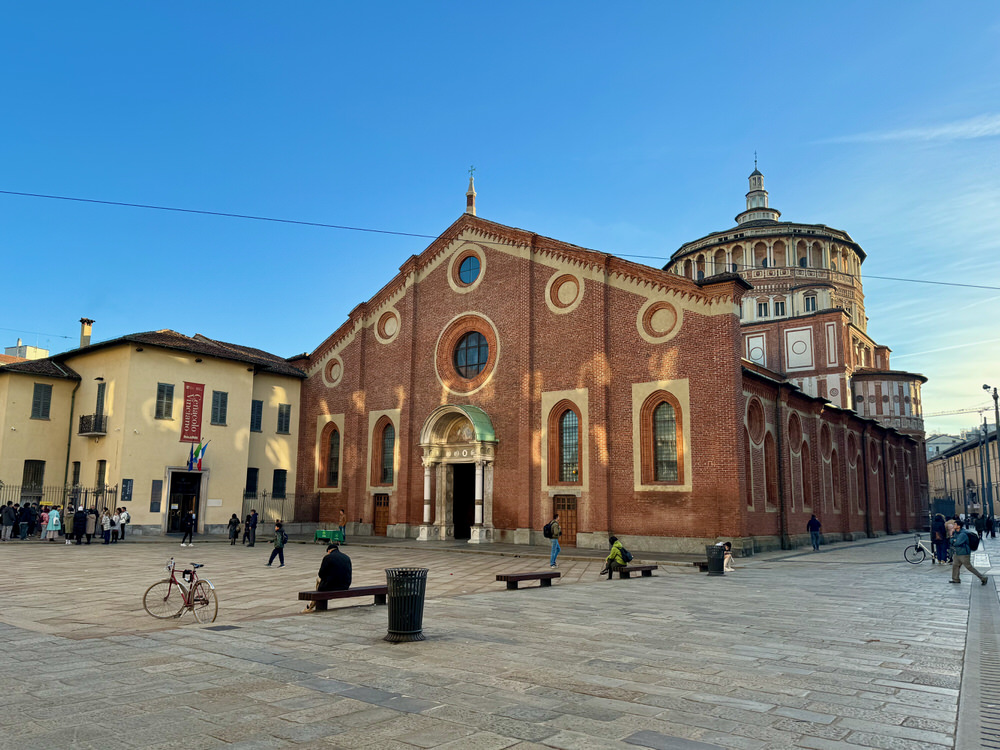 Exterior of Renaissance era Italian church Santa Maria della Grazie and courtyard on a sunny day