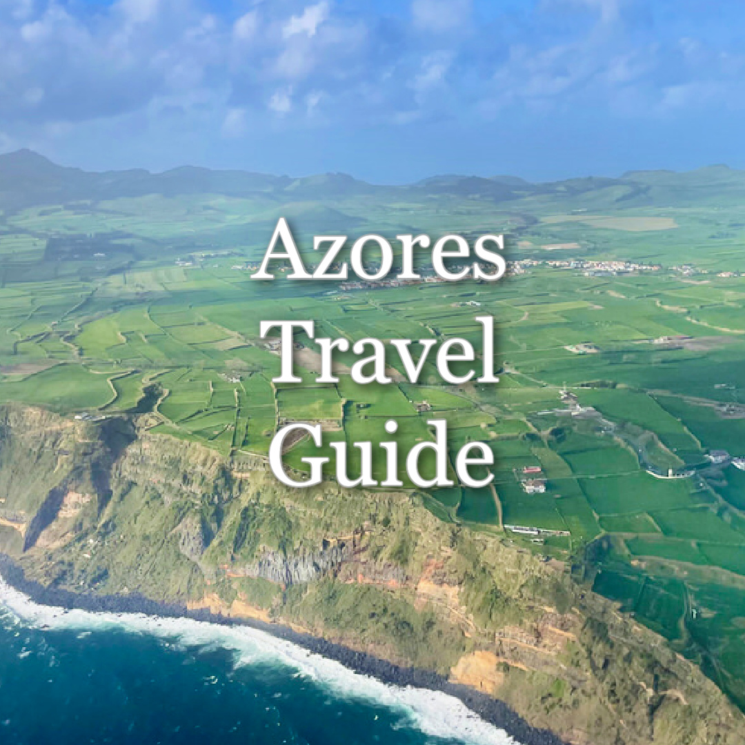 Birds-eye view of Sao Miguel Island with ocean, cliffs, and green fields pictured. Text reads "Azores Travel Guide." 