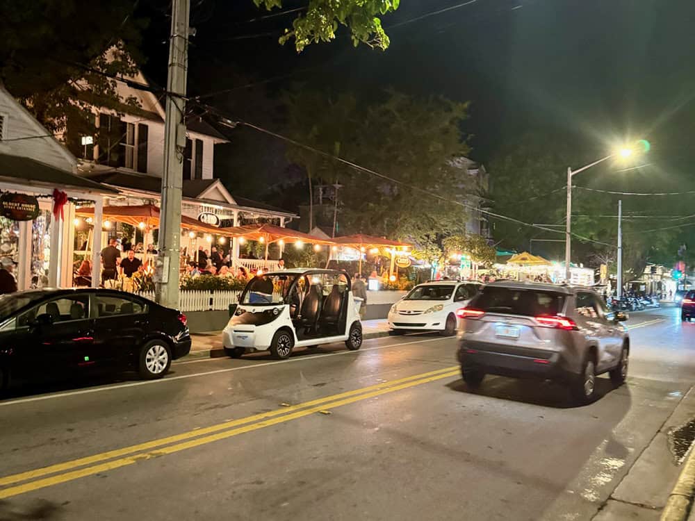 Cars parked along Duval Street at night in Key West