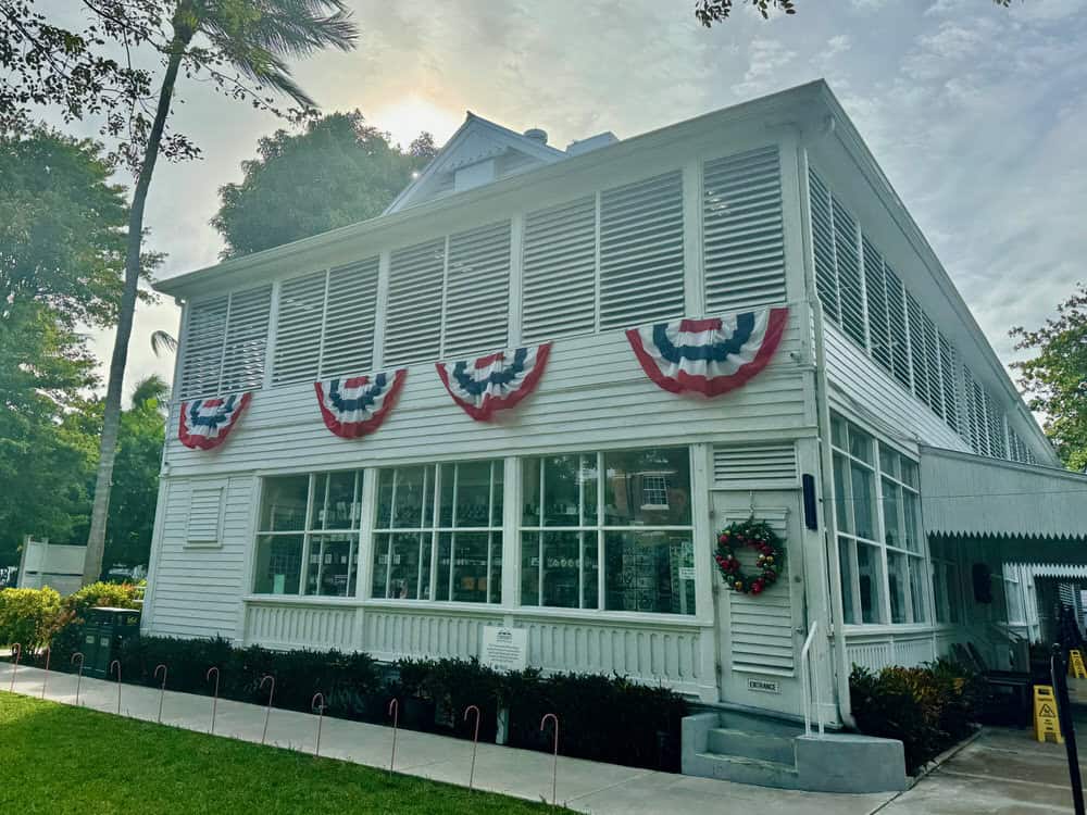 Exterior of the Truman Little White House with patriotic bunting hung from the second floor windows