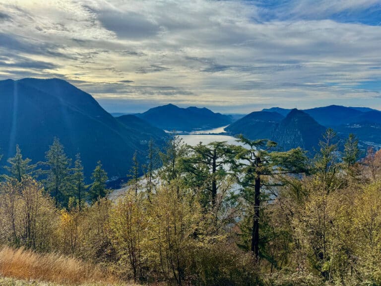 Wooded visit of Lake Lugano framed by the Lugano Prealps mountains looking towards northern Italy's lake district.