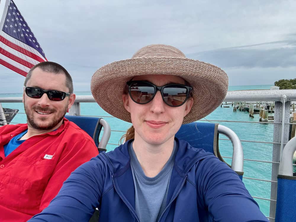 A man and woman sit on the upper deck of a passenger ferry in Key West Florida