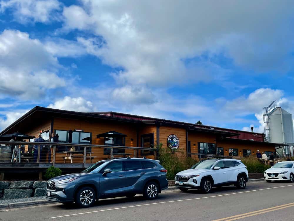 Cars parked in front of Castle Danger Brewery on a sunny October Saturday
