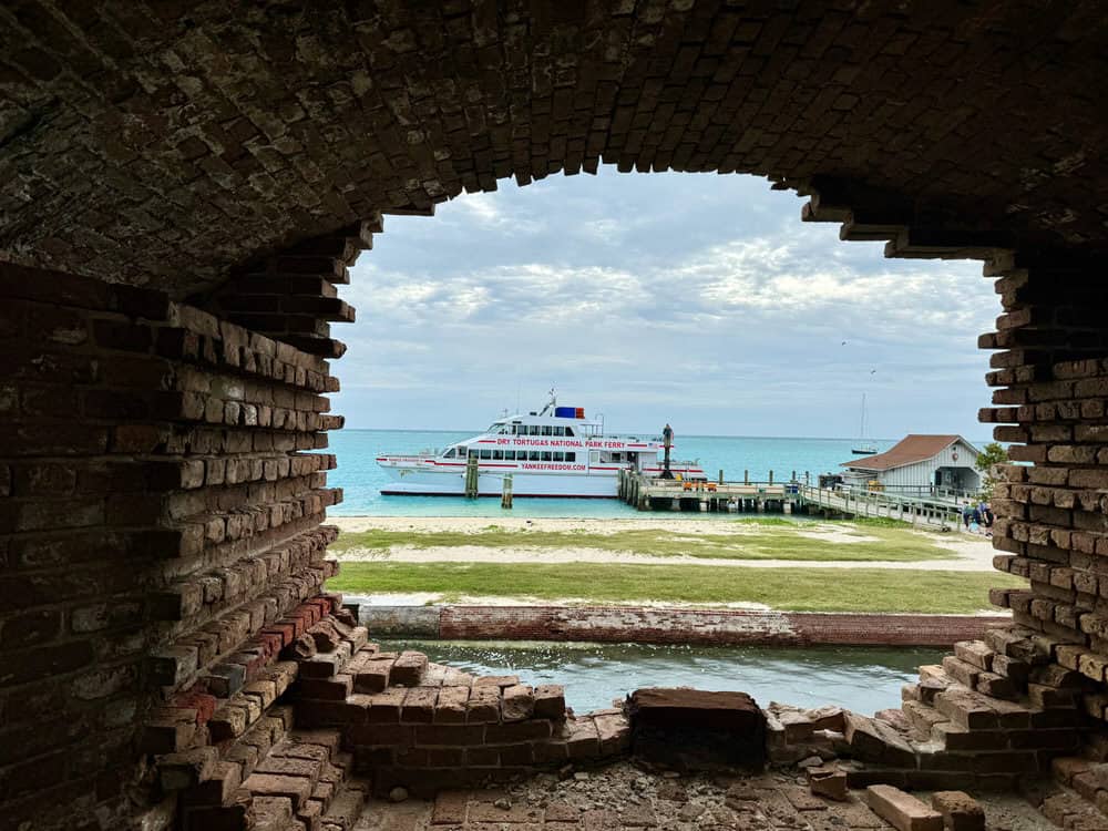 Dry Tortugas dock with the ferry boat in port as seen through a window in Fort Jefferson