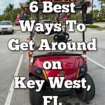 Red golf cart decorated for Christmas parked in a Key West parking lot. Text overlay reads "6 Best Ways to get around on Key West, FL"