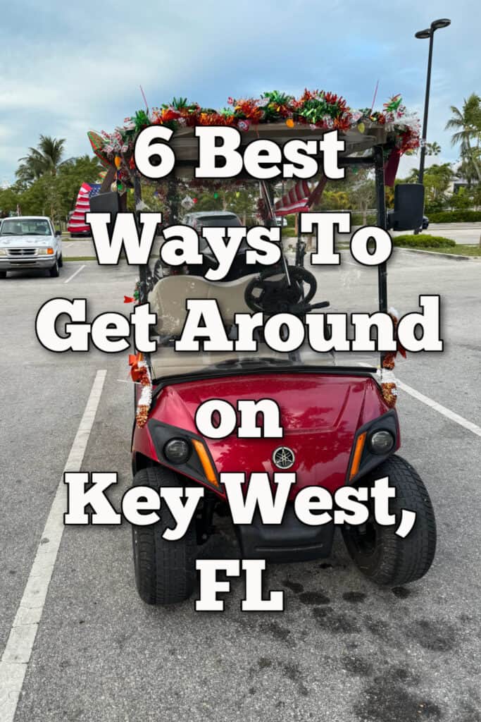 Red golf cart decorated for Christmas parked in a Key West parking lot. Text overlay reads "6 Best Ways to get around on Key West, FL"