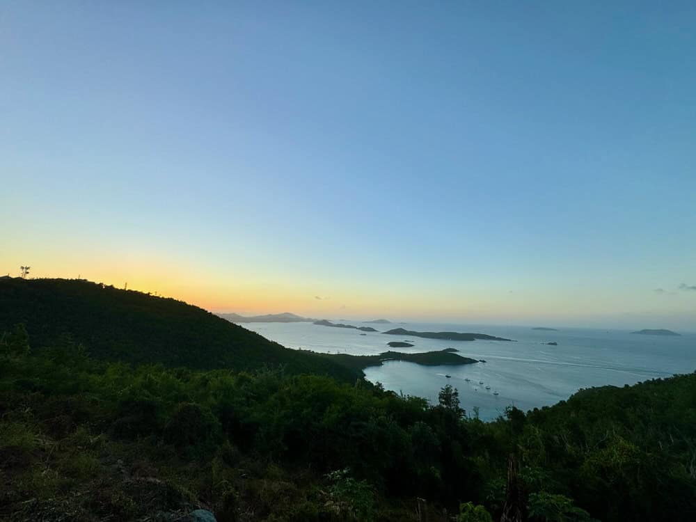 The sun sinks behind a mountain on St. John USVI