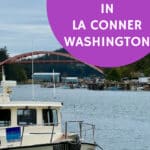A small pleasure boat docked in the La Conner marina with the Rainbow bridge and Swinomish Channel in the background. Text overlay reads "Best Things To Do in La Conner Washington."