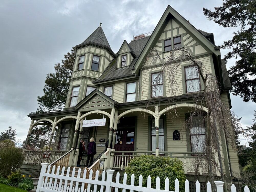 Large green Victorian mansion with a white picket fence in La Conner Skagit Valley Washington