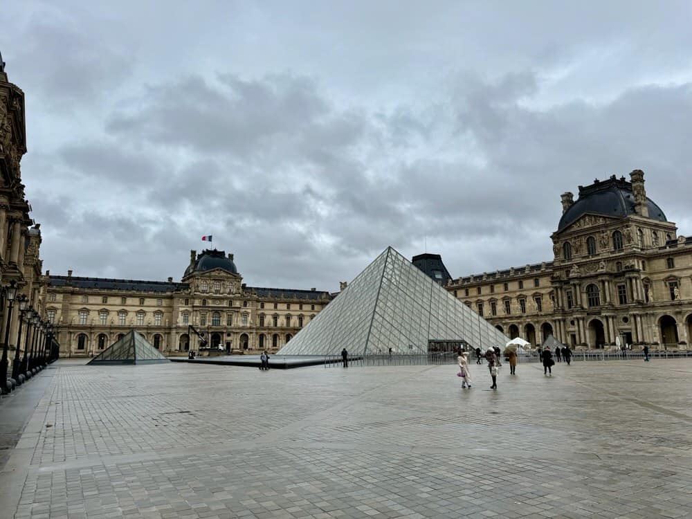 Glass pyramid in Louvre castle courtyard