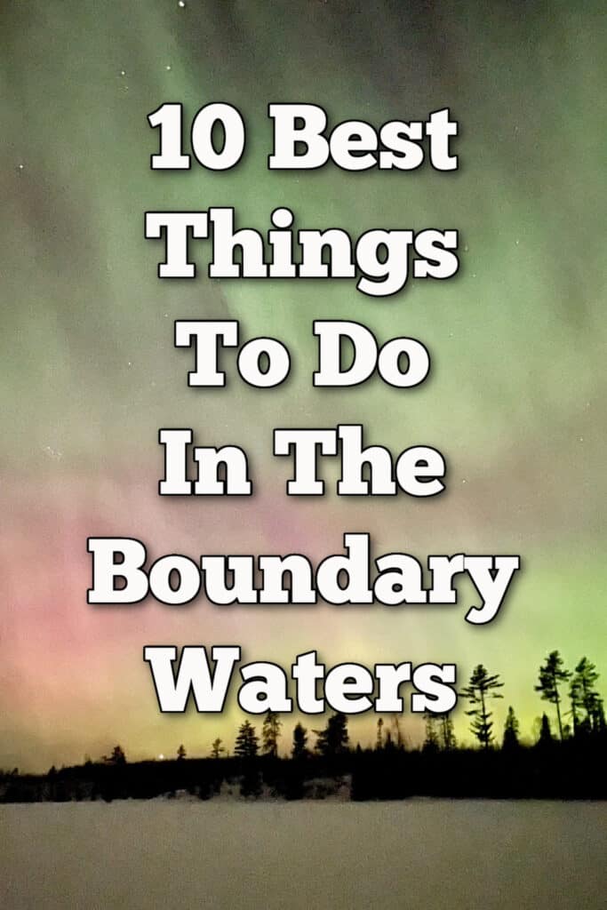 Northern lights shine pink and green over a frozen lake in northern Minnesota. Text overlay reads "10 Best Things To Do in the Boundary Waters."