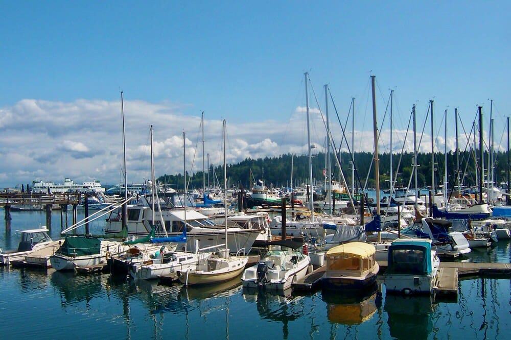 A variety of pleasure boats in Eagle Harbor, Bainbridge Island with a public ferry in the background.