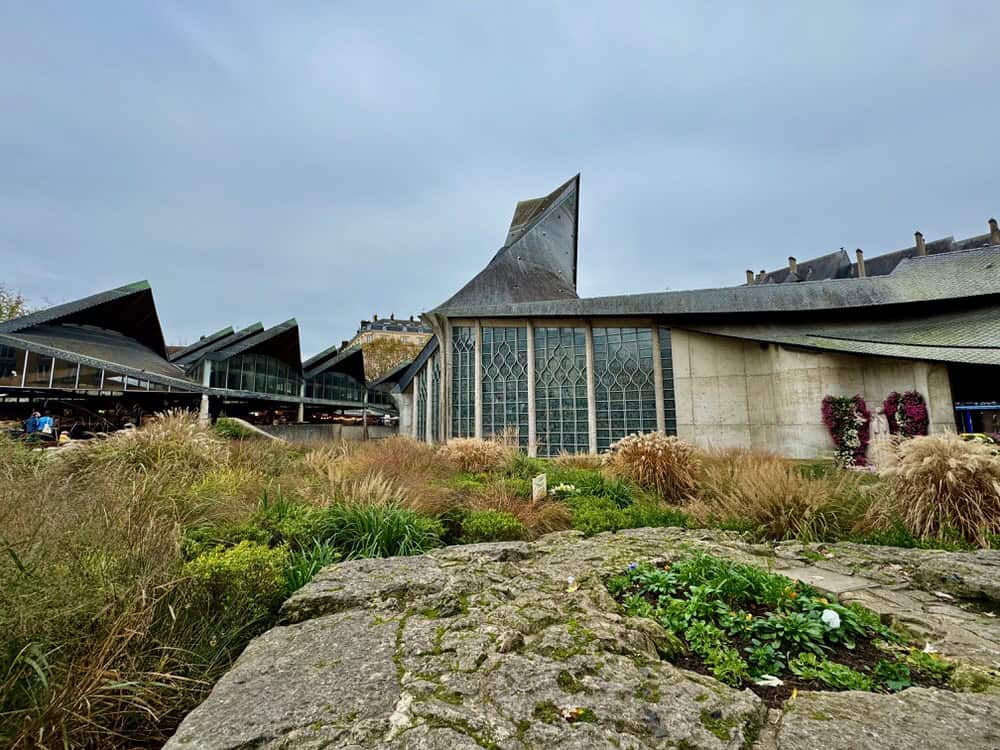 Modern church with distinctive pointy room stands in a middle of a square in Rouen France