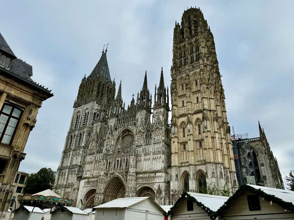 Exterior of the Gothic cathedral in central Rouen. Huts for a Christmas village are in front.