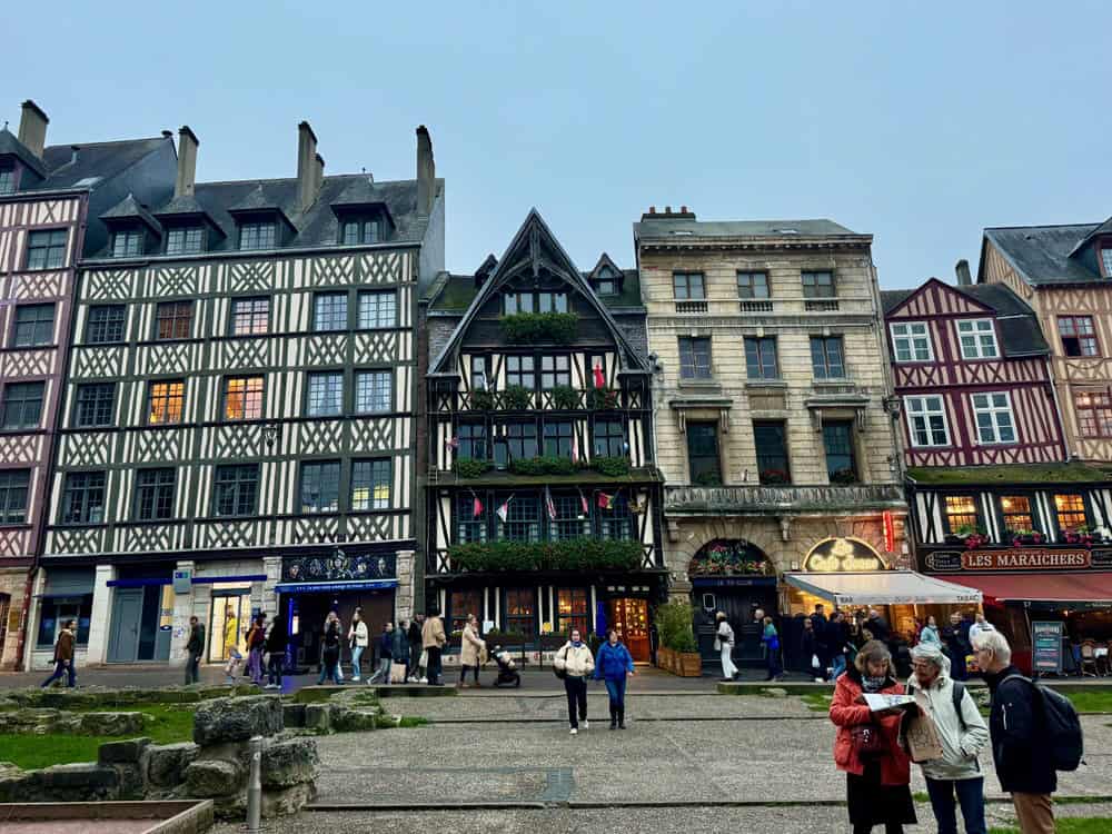 A busy European square lined with half timbered buildings