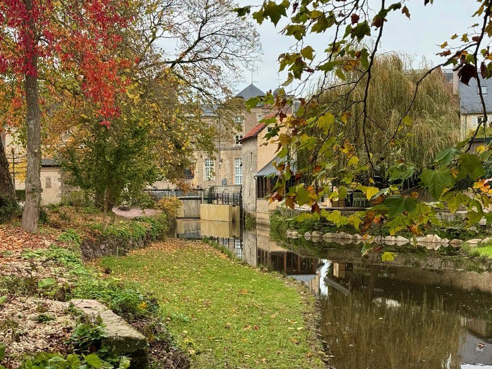 Green banks of the Aure River near downtown Bayeux