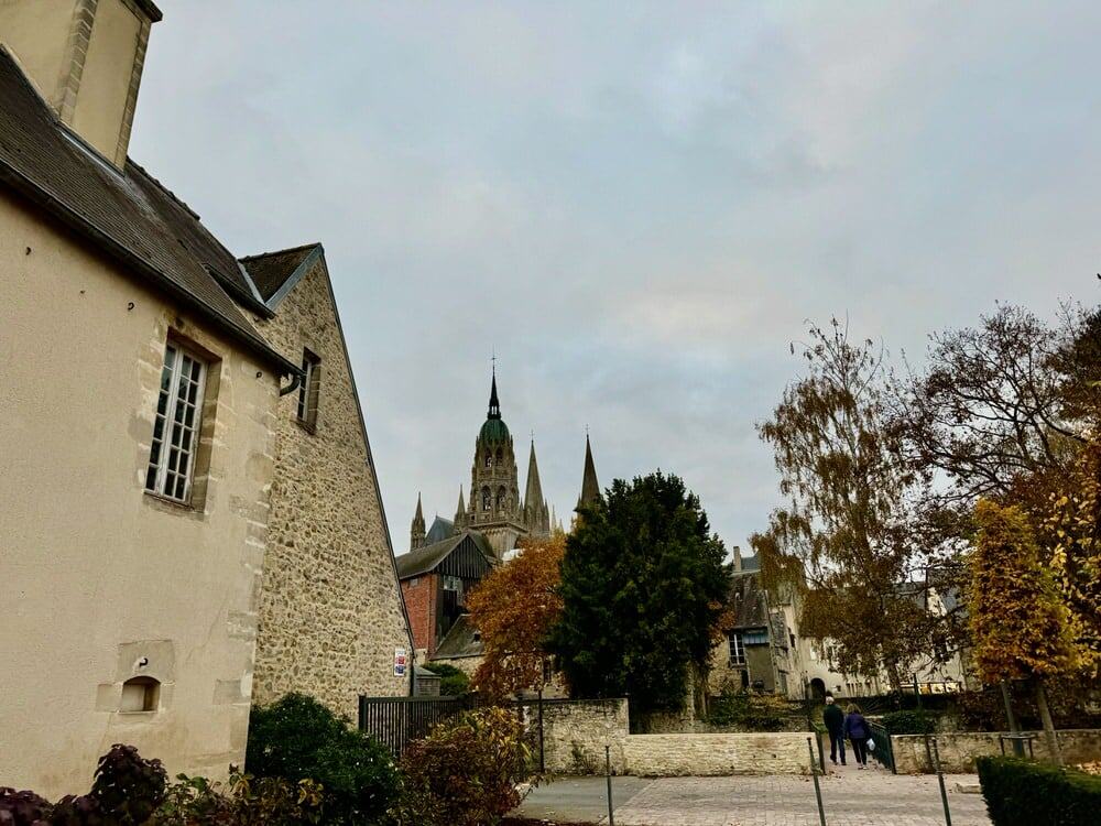 Cobblestone streets and trees with autumn foliage in Bayeux's historic city center