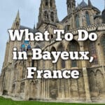 Exterior of Bayeux Cathedral. Text overlay reads "What To Do in Bayeux, France."