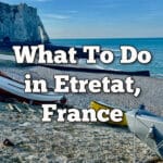 Boats on the beach in front of Etretat cliffs. Text overlay reads "What to do in Etretat, France."
