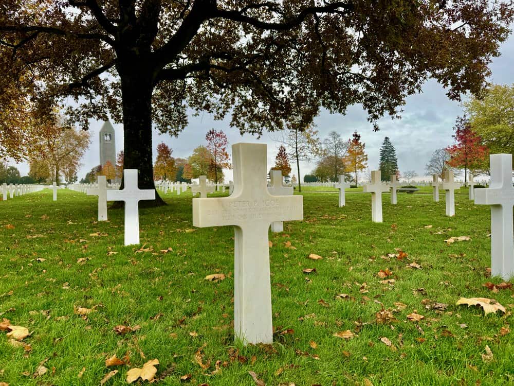 White cross with the name of a U.S. World War II serviceman in the Brittany American cemetery in late autumn