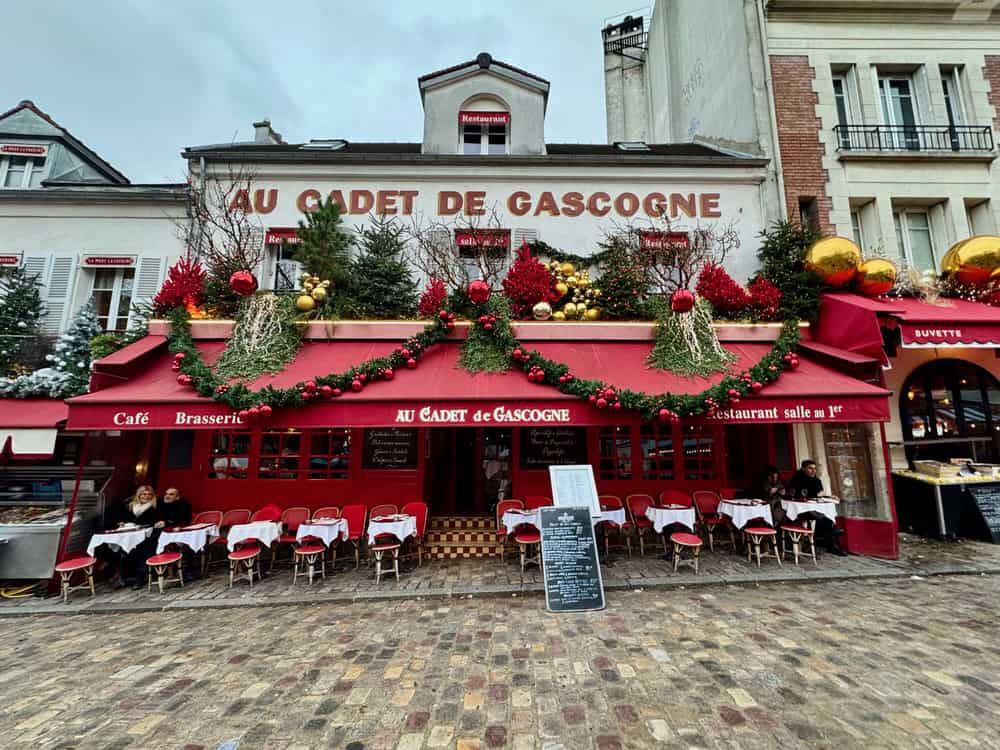 Red and white cafe in Paris Montmartre neighborhood decorated for Christmas