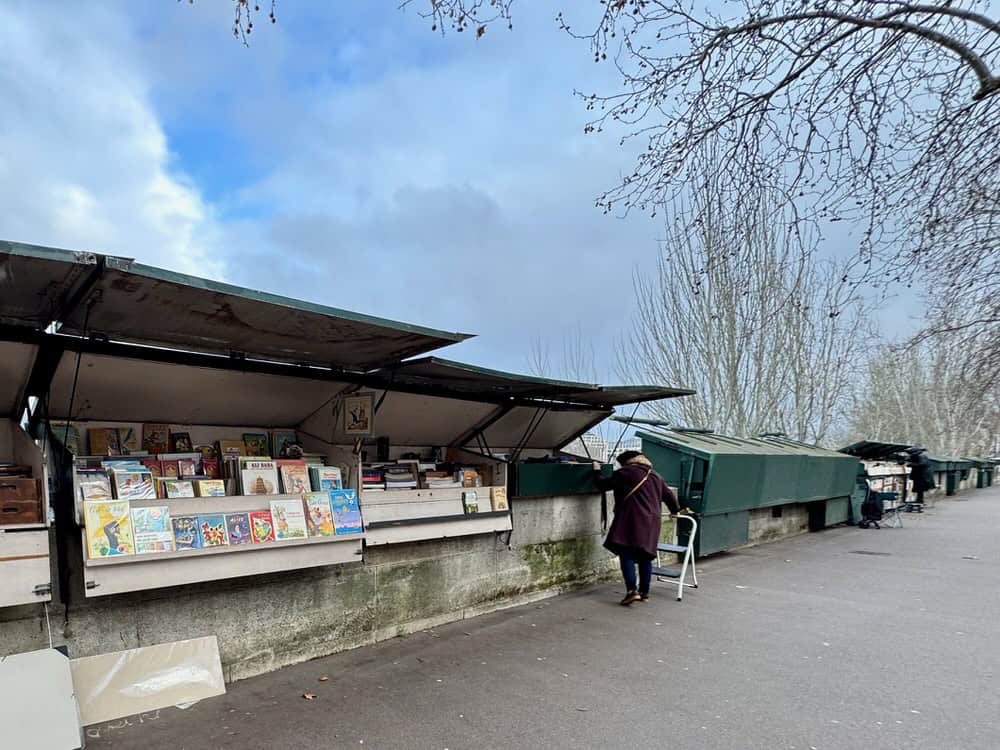 Wooden booths filled with antique books and prints line the banks of the Seine River