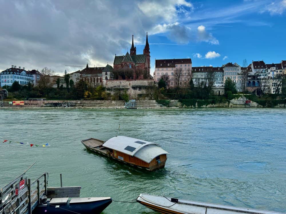 Looking across the Rhine River at a ferry boat and the Basel Munster