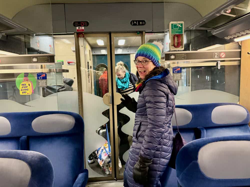 Woman stands in an aisle of a regional French train