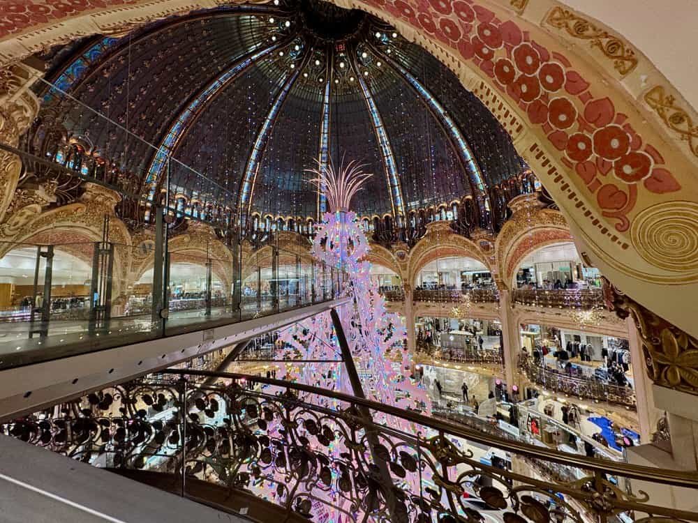 Glass ceiling in Paris department store with Christmas decorations and observation deck.