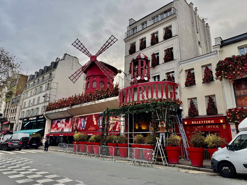 Exterior of Paris's Moulin Rouge night club covered with red and gold Christmas decorations