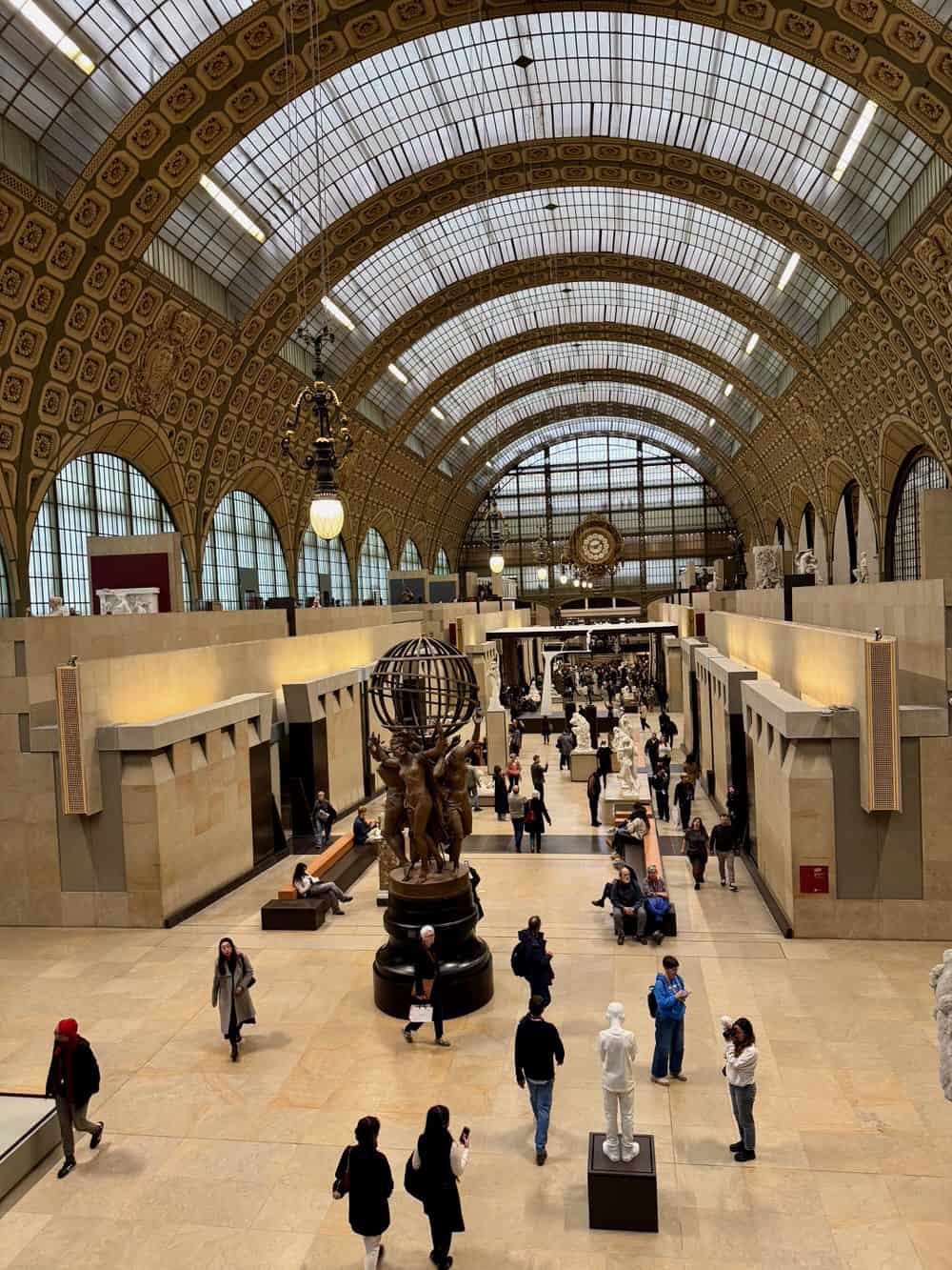Looking across the sculpture garden under the old train station roof in Musee D'Orsay