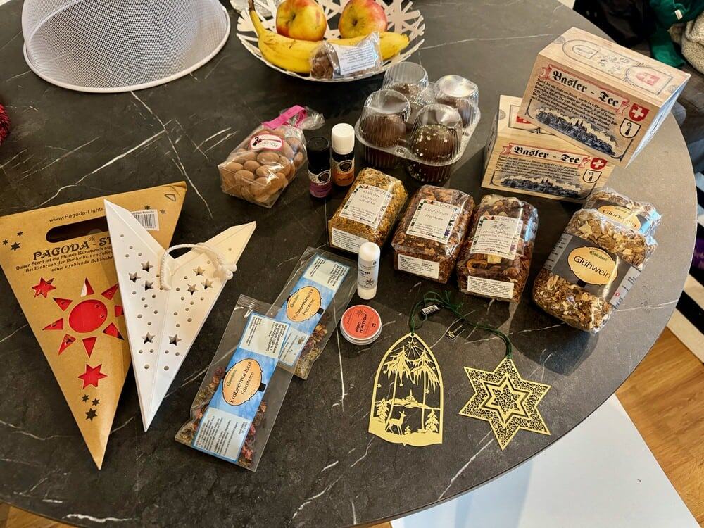 Christmas market purchases including ornaments, tea, and decorations laid out on a table