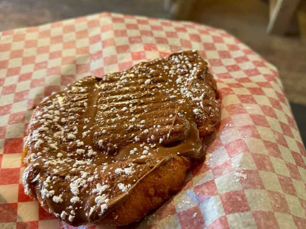 Fried sweet dough covered with nutella spread and powdered sugar